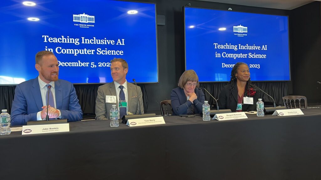 Four people sit on a panel at the White House