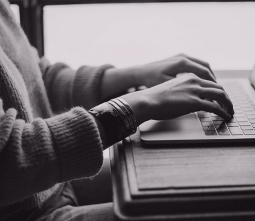 Hands on a laptop keyboard