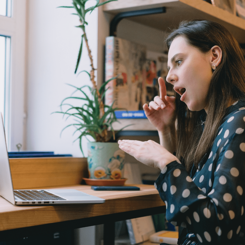 Woman signing with ASL to an online meeting